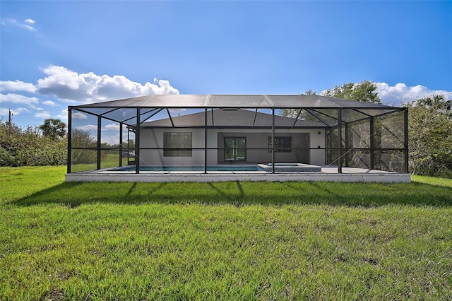 rear view of property featuring a lanai and a yard