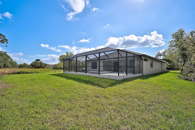 rear view of property featuring a lanai and a lawn