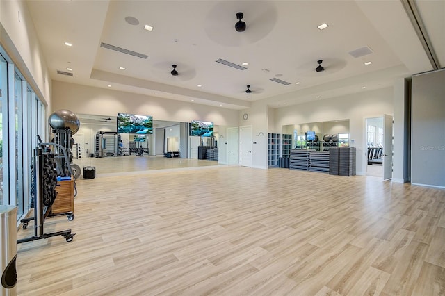 exercise room with ceiling fan and light hardwood / wood-style floors