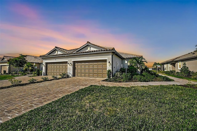 view of front facade with a lawn and a garage