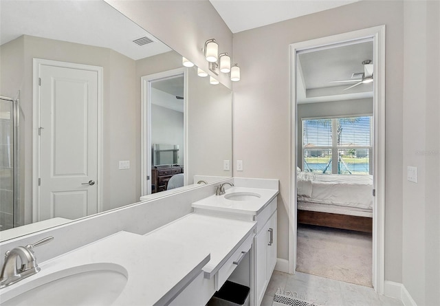 bathroom with vanity, a shower with door, tile patterned floors, and ceiling fan