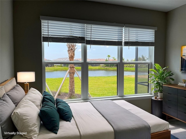 bedroom featuring a water view