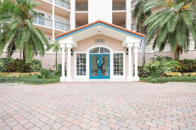 5450 Eagles Point Cir Unit 405, Sarasota, FL 34231 - view of exterior entry with french doors and stucco siding