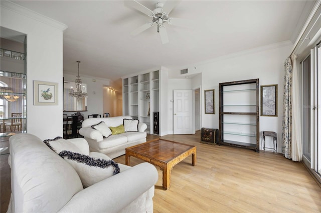 living room with crown molding, light hardwood / wood-style floors, and ceiling fan with notable chandelier