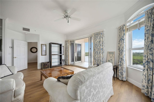 living room with ceiling fan, light hardwood / wood-style floors, and crown molding