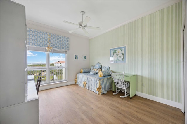 bedroom with light hardwood / wood-style flooring, ceiling fan, and ornamental molding