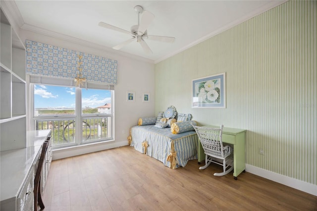 bedroom with ceiling fan, crown molding, and light hardwood / wood-style floors