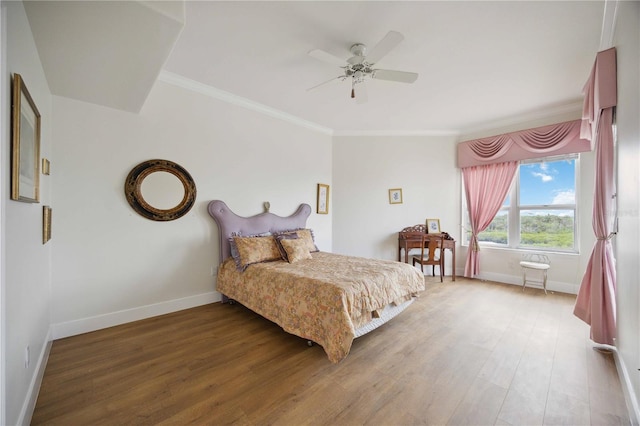 bedroom featuring hardwood / wood-style flooring, ceiling fan, and crown molding