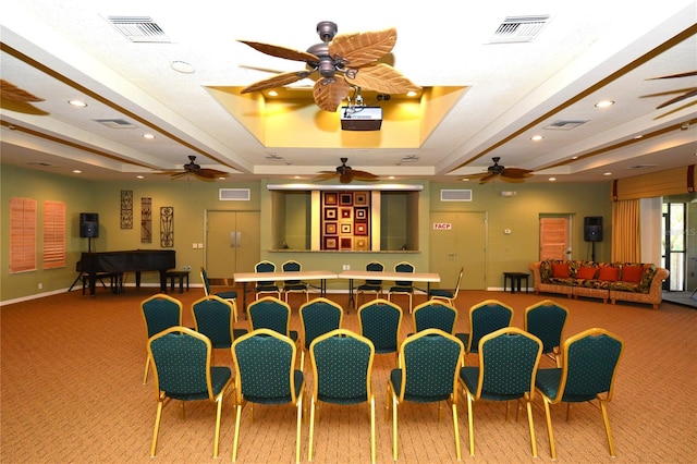 carpeted cinema featuring a tray ceiling