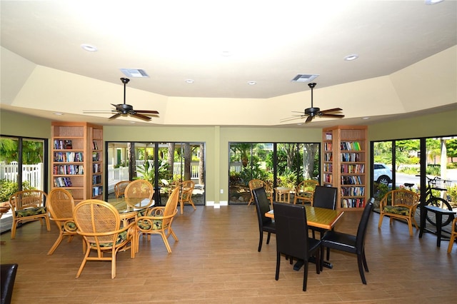 dining room with ceiling fan, plenty of natural light, and wood-type flooring