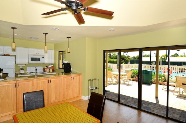 kitchen featuring white cabinets, ceiling fan, white appliances, and light hardwood / wood-style flooring