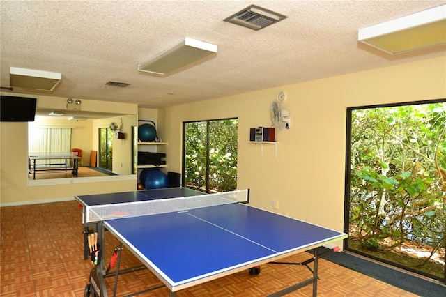 playroom with parquet floors and a textured ceiling