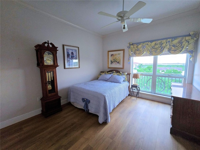 5450 Eagles Point Cir Unit 405, Sarasota, FL 34231 - bedroom with crown molding, wood finished floors, ceiling fan, and baseboards