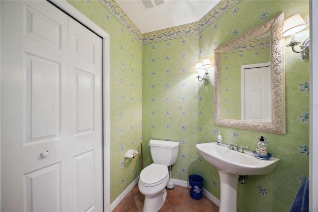 5450 Eagles Point Cir Unit 405, Sarasota, FL 34231 - half bathroom featuring tile patterned floors, toilet, wallpapered walls, and baseboards
