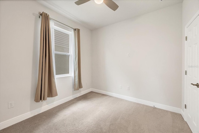 carpeted empty room featuring ceiling fan