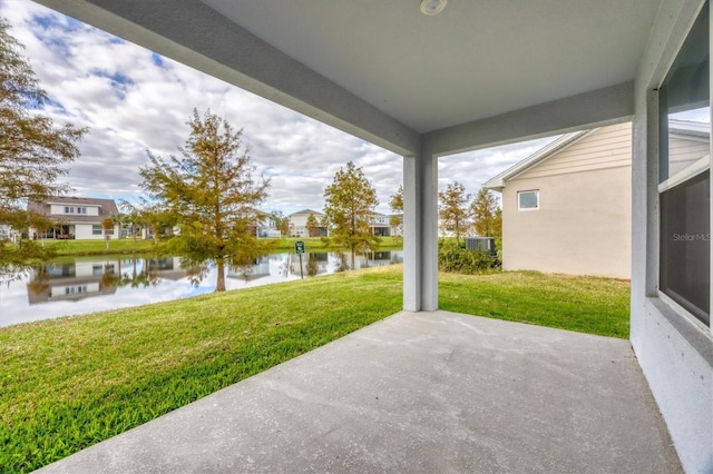 view of patio featuring a water view and central AC unit