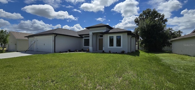 prairie-style home with a front yard and a garage