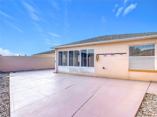 back of house featuring a sunroom and a patio