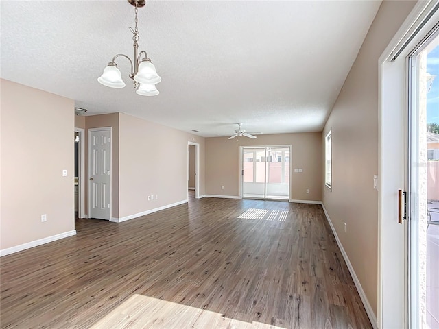 spare room featuring hardwood / wood-style flooring and ceiling fan with notable chandelier