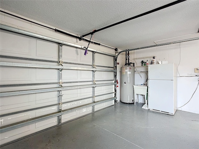 garage featuring sink, electric water heater, and white fridge