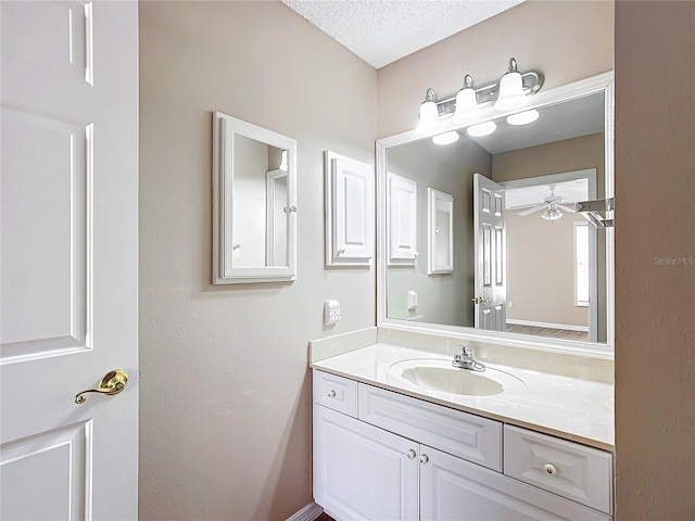 bathroom with vanity, a textured ceiling, and ceiling fan