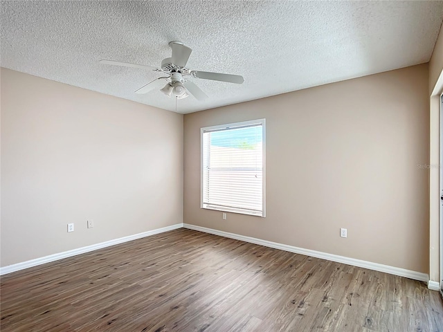 spare room with ceiling fan, hardwood / wood-style floors, and a textured ceiling