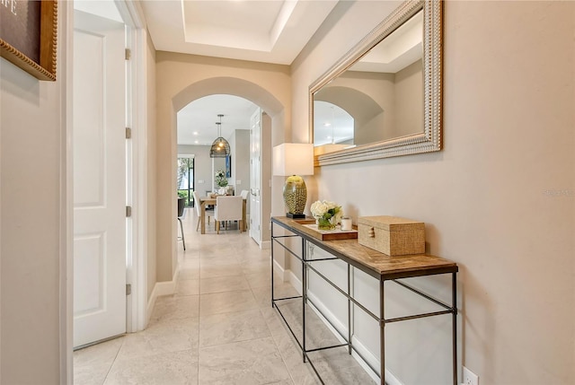 hall featuring light tile patterned floors