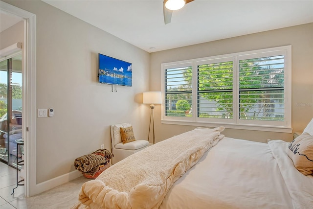 bedroom with light tile patterned floors, multiple windows, and ceiling fan