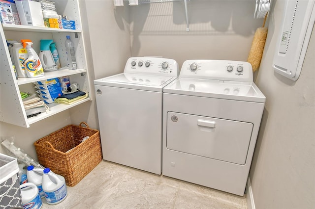 clothes washing area featuring washer and dryer