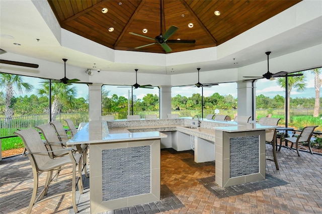 view of patio / terrace featuring a gazebo, ceiling fan, and an outdoor wet bar