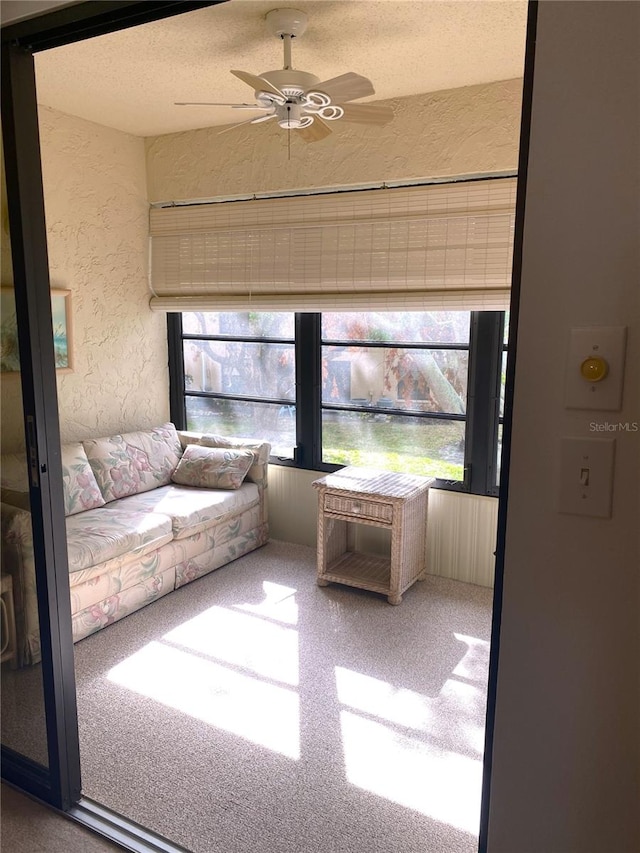 unfurnished sunroom featuring a wealth of natural light and ceiling fan