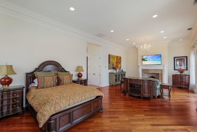 309 Ringling Point Dr, Sarasota, FL 34234 - bedroom with a chandelier, ornamental molding, recessed lighting, wood finished floors, and a fireplace
