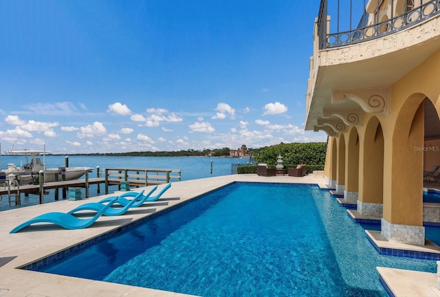309 Ringling Point Dr, Sarasota, FL 34234 - outdoor pool with a water view, a dock, and a patio area