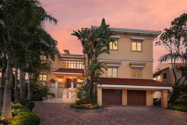 309 Ringling Point Dr, Sarasota, FL 34234 - mediterranean / spanish home with stucco siding, decorative driveway, and an attached garage
