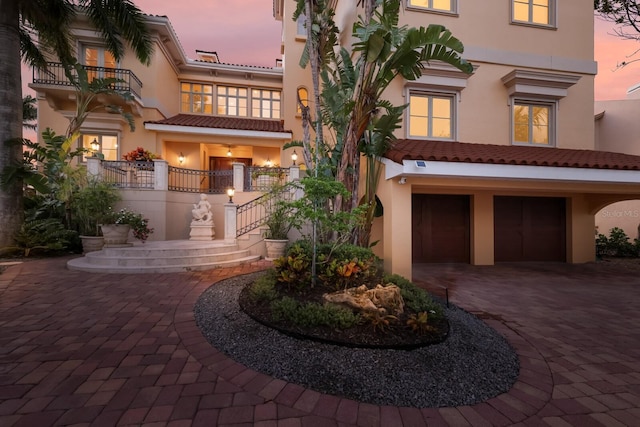 309 Ringling Point Dr, Sarasota, FL 34234 - mediterranean / spanish-style home with stucco siding, a garage, decorative driveway, and stairs