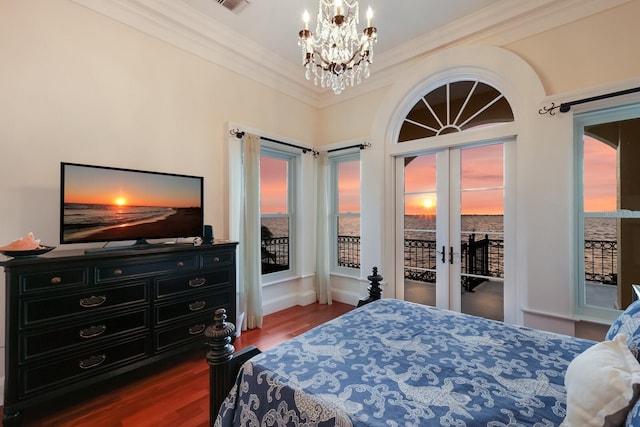 bedroom with access to exterior, a notable chandelier, dark hardwood / wood-style flooring, and multiple windows