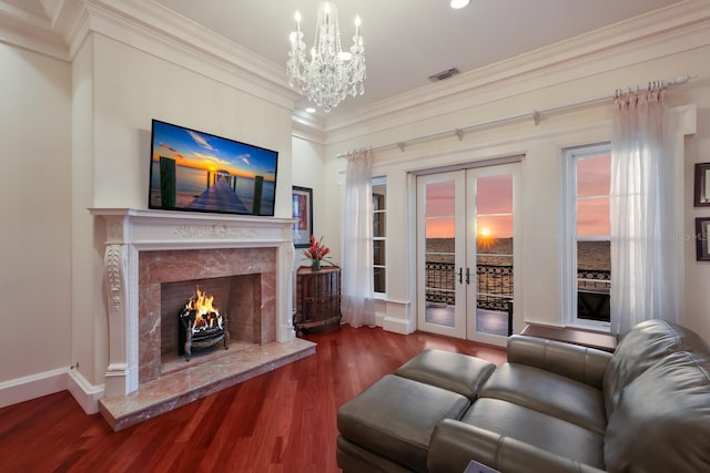 309 Ringling Point Dr, Sarasota, FL 34234 - living room featuring wood finished floors, ornamental molding, a chandelier, baseboards, and french doors