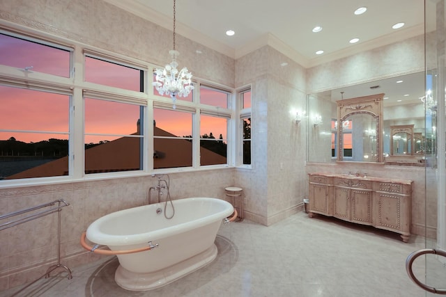 309 Ringling Point Dr, Sarasota, FL 34234 - full bath featuring tile walls, ornamental molding, a freestanding tub, a chandelier, and vanity