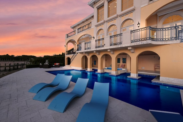 309 Ringling Point Dr, Sarasota, FL 34234 - pool at dusk featuring a patio area and a pool with connected hot tub