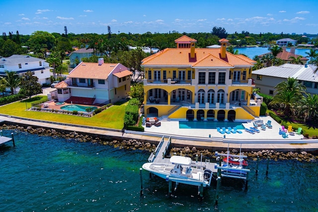 back of house featuring a balcony and a water view