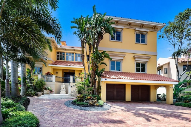 mediterranean / spanish-style house with a garage