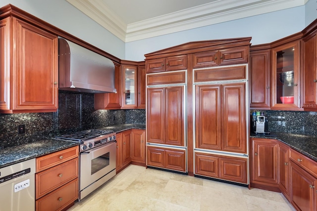 kitchen featuring backsplash, stainless steel appliances, dark stone countertops, and wall chimney range hood