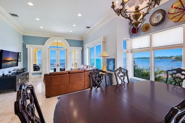 dining space featuring french doors, a water view, ornamental molding, and a notable chandelier