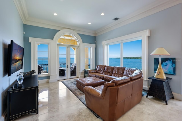 living room featuring a healthy amount of sunlight, a water view, and ornamental molding