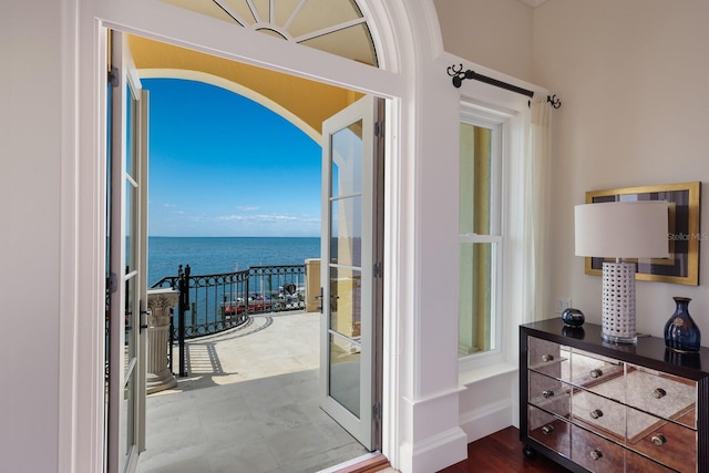 entryway featuring a water view and wood-type flooring