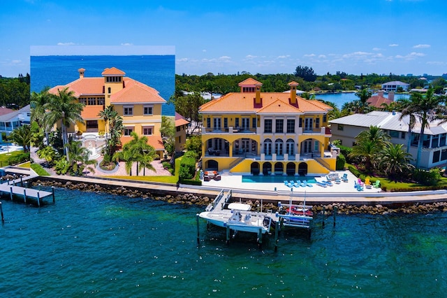 309 Ringling Point Dr, Sarasota, FL 34234 - back of house featuring a water view, boat lift, a balcony, and a chimney