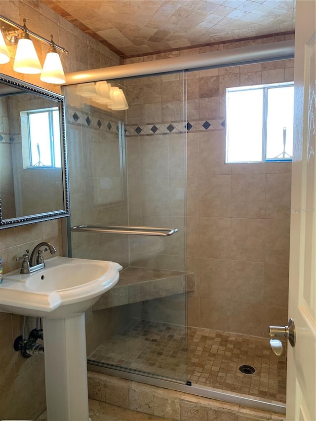 bathroom featuring a shower with door