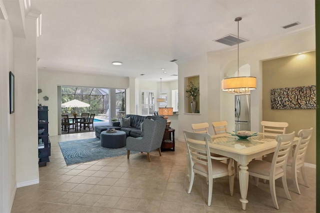 dining room featuring light tile patterned floors and a chandelier