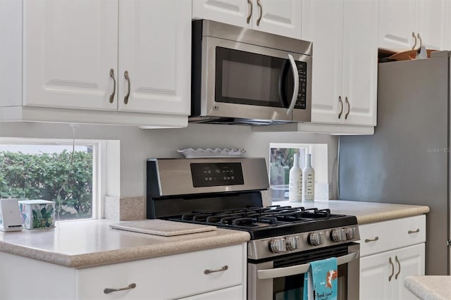 kitchen with white cabinetry and appliances with stainless steel finishes