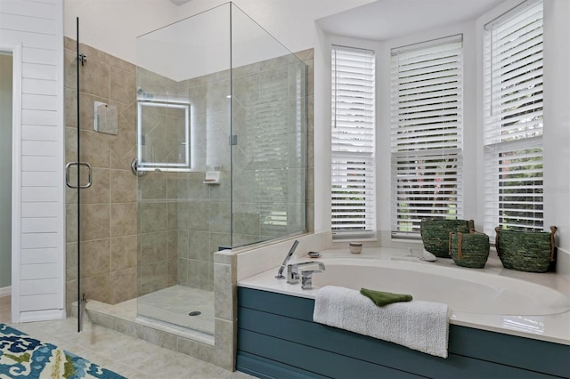 bathroom with tile patterned flooring, plenty of natural light, and separate shower and tub